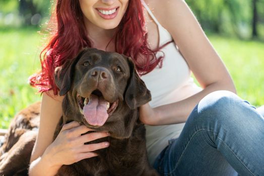 Woman in the park hugs a dog. Spend time with pets