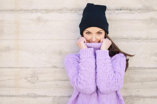 Happy young woman wearing winter hat. Lifestyle concept.