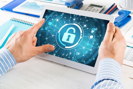 close-up, male hands with tablet. Businessman working at the table in office. computer security concept