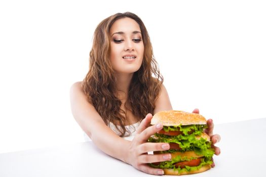 Happy Young Woman Eating big yummy Burger isolated on white background