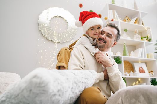 Young dad and his son celebrate christmas together, portrait