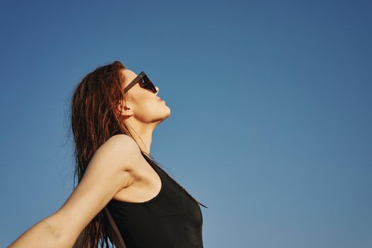 woman in black swimsuit sunglasses sun nature. High quality photo