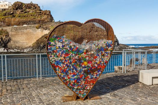 Conceptual garbage can heart-shaped for plastic nuts. Education in environmental protection.