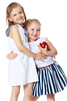 Two cute little girls with apples, in the studio on a white background. Concept of happy childhood, healthy eating. Isolated.