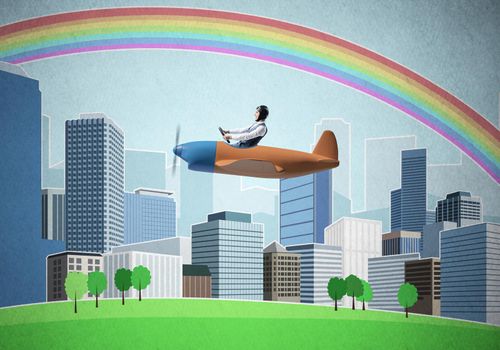 Businessman flying in small propeller plane above metropolis. Aviator driving retro airplane on background of city. Cityscape with high skyscrapers and colorful rainbow. Flying dreams concept