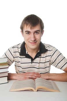 Male student at the table with a pile of books over white