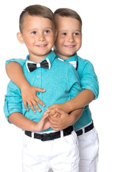 Two cute little boys, brothers close-up. The concept of a happy childhood, the development of a child in the family. Isolated on white background.