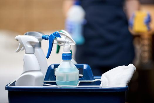 Close up of basket of cleaning tools for hotel room cleaning. Housekeeping and hygiene concept