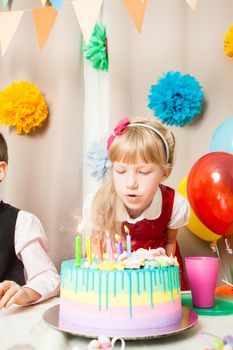 little girl wants to make a wish before blowing candles