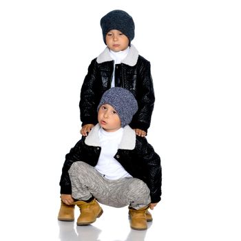 Studio portrait of boys in black leather jackets.Isolated on white background.