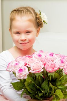 Little girl with a beautiful bouquet of flowers. The concept of holidays, family and children.