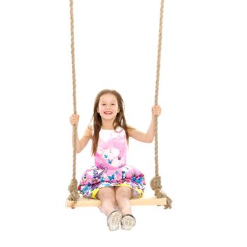 Adorable little girl swinging on a swing. She is happy to have fun and show how she can do it. The concept of summer recreation and harmonious development of the child. Isolated on white