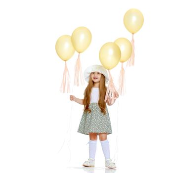 Little girl is playing with a balloon. The concept of a holiday, a birthday, a holiday in the fresh air. Isolated on white horse