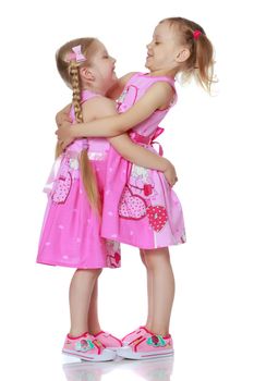 Two cute little girls in full growth, in the studio on a white background. The concept of a happy childhood, Beauty and fashion. Isolated.