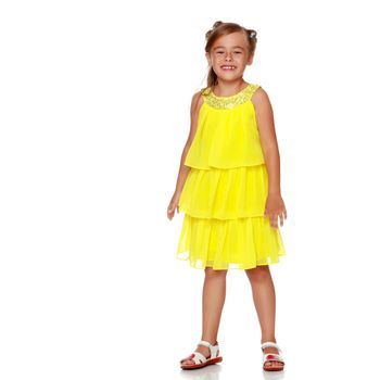 Fashionable little girl in a dress. Beauty and style in children's clothes. Isolated over white background