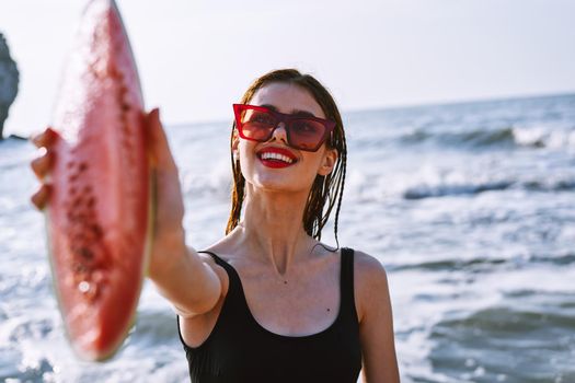 cheerful pretty woman in black swimsuit watermelon fashion travel. High quality photo