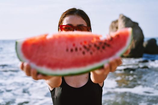 cheerful pretty woman in black swimsuit watermelon fashion travel. High quality photo