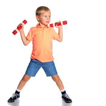 The little boy is engaged in fitness, he lifts dumbbells in the gym. The concept of a happy childhood, the development of children's sports. Isolated on white background.