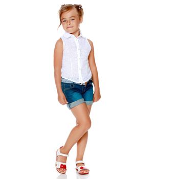 Beautiful little girl in shorts. The concept of fashion, summer holidays. Isolated on white background.