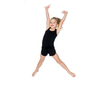 A little girl gymnast joyfully jumps and wags her hands. The concept of sport and fitness. Isolated over white background