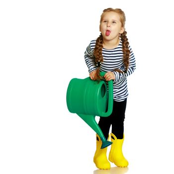 A little girl is holding a garden watering can. The concept of ecology, healthy lifestyle. Isolated on white background.