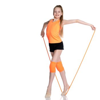 A girl gymnast performs exercises with a skipping rope. The concept of a healthy lifestyle, sports education of a child, Happy childhood. Isolated on white background.