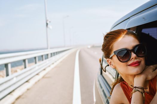 pretty woman in sunglasses rides in a travel car. High quality photo