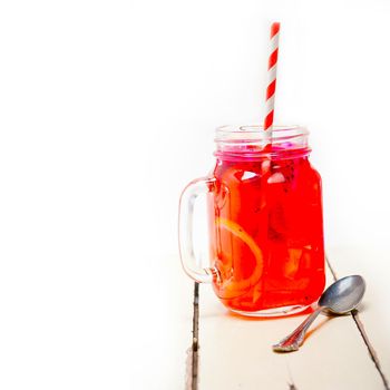 fresh fruit punch refreshing summer  drink over white rustic wood table