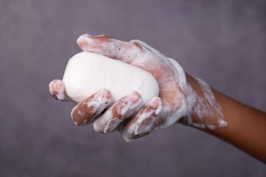 young man washing hands with soap warm water.