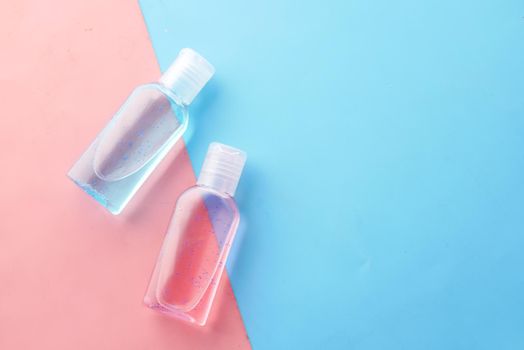 hand sanitizer liquid in a plastic bottle on color background .