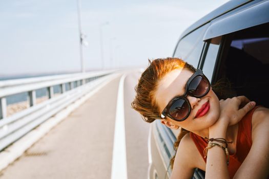 pretty woman in sunglasses rides in a travel car. High quality photo