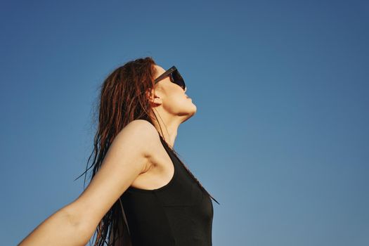 woman in black swimsuit sunglasses sun nature. High quality photo