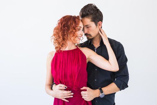 Social dance, bachata, kizomba, salsa, tango concept - Close up portrait of woman man dressed in beautiful outfits over white background.