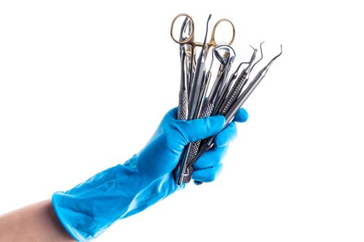 Closeup of hands in blue gloves holding dental equipment isolated on white background