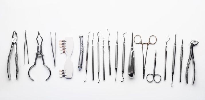 Different dental metal tools on white table