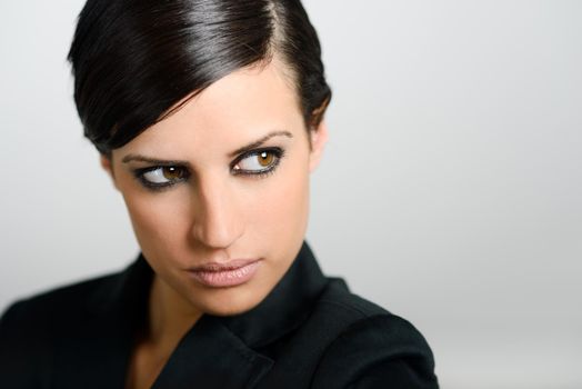 Portrait of woman with intense look on white background. Studio portrait