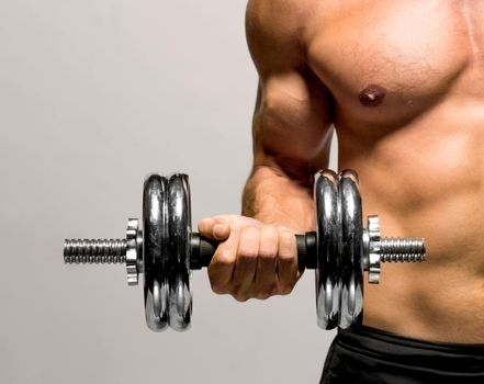 Fitness - powerful muscular man lifting weights