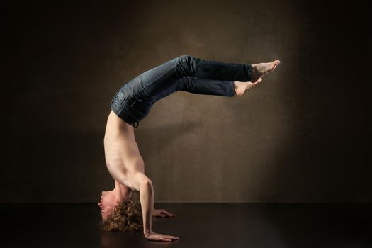 Young and stylish modern dancer on grey grunge background