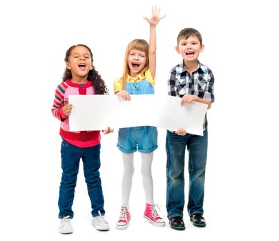 three children with open mouths holding empty sheet of paper isolated on white background