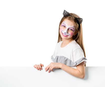 Lovely little girl with face painting holding white blank banner isolated on white background. Copyspace