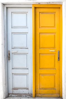 Traditional colorful rustic white and yellow doors of Greek island