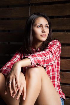 young woman in cowboy clothes on wooden background