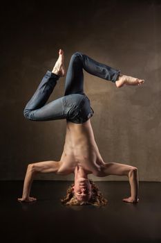 Young and stylish modern dancer on grey grunge background