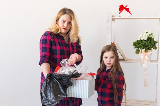 Environmental protection and pollution concept. Surprised woman holds box with plastic trash