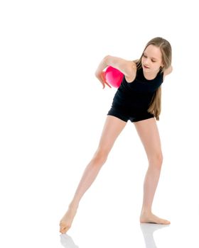 A charming little girl is engaged in fitness with a ball. The concept of gymnastics, health and sports. Isolated on white background.