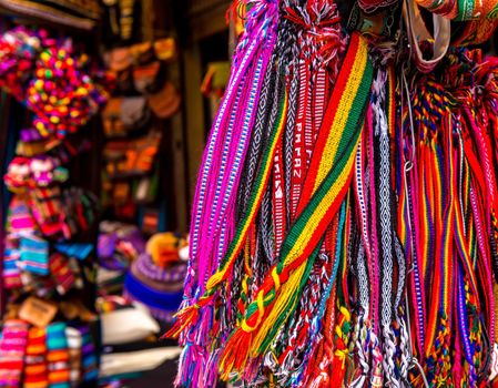 Different colorful laces with patterns hanging on the souvenir store in Bolivia