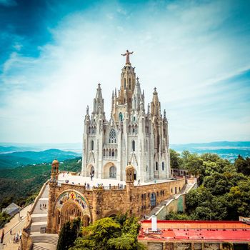 Tibidabo church on mountain in Barcelona with christ statue overviewing the city