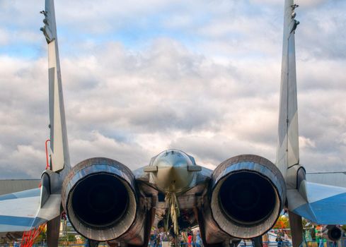 rear detailed view of air fighter on the ground  with blue sky in background