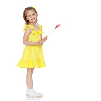 Little girl with a candy on a stick. The concept of sweets, festive mood, birthday, happiness, child, Happy childhood. Isolated over white background