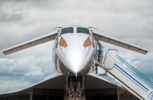 supersonic jet plane on the ground boarding with blue sky in background